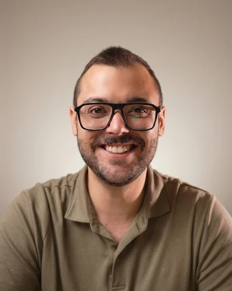 Adrián Cuñat Andrés, de frente, con polo verde y gafas de pasta, sonriendo